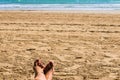 Woman feet in the sand with red painted nails Royalty Free Stock Photo