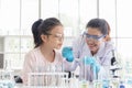 Image of woman teacher and girl student in lab science class. Young girl excited in lab class with scientist