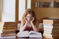 Image of woman teenager sitting in reding room, lady reading book, preparing for final examination, finding out information, has