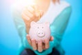 Image of woman throwing coin into piggy bank Royalty Free Stock Photo