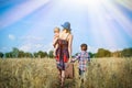 Image of woman wearing hat with baby girl walking