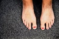 Womans feet on a grey background Royalty Free Stock Photo