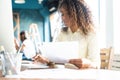 Young african american businesswoman sitting in the office and working on laptop. Royalty Free Stock Photo