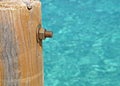 Image of the wood, the bolt, nut in the pier at sea .