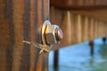 Image of the wood, the bolt, nut in the pier at sea .