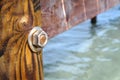 Image of the wood, the bolt, nut in the pier at sea .