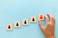 Image of wooden blocks with people icon over blue table ,building a strong team, human resources and management concept Royalty Free Stock Photo