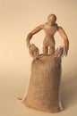 Human-shaped mannequin dragging a burlap cloth sack Royalty Free Stock Photo