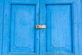 Blue old door with paddle key lockset. Royalty Free Stock Photo