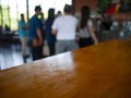 Image of wooden table in front of abstract Blurred background : Customers are waiting  in a coffee shop blur background with bokeh Royalty Free Stock Photo