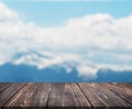 Image of wooden table in front of abstract blurred background of mountain. can be used for display or montage your products. Mock