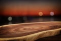 Image of wooden table in front of abstract blurred yachts in pier at sunset Royalty Free Stock Photo