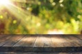 Image of wooden table in front of blurred vineyard landscape at sun light. Ready for product display montage. Royalty Free Stock Photo