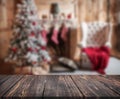 Image of wooden table in front of christmas blurred background o Royalty Free Stock Photo