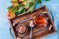 Image of wooden tray with cup , flowers, mafin with cream Royalty Free Stock Photo