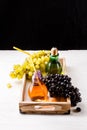 Image of wooden tray with green and black grapes, two bottles of juice Royalty Free Stock Photo