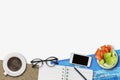 Image of work from home concept show flexible working hour with graph and chart, glasses, book, fruits, mobile phone and coffee on