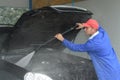 Image worker cleaning cars engine with karcher