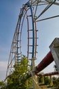 Worm's eye view of abandoned roller coaster in a broken down theme park