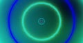 Image of yellow, blue, pink and green pulsating neon circles on green background Royalty Free Stock Photo