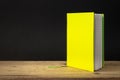 a yellow green note book on a wooden table Royalty Free Stock Photo