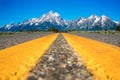 Yellow highway dividing lines with beautiful landscape from Grand Teton National Park Royalty Free Stock Photo