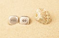 image of yes go cube seashell sand background