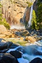 Yosemite stunning lower falls in early spring with rainbow and cascading icy river Royalty Free Stock Photo