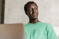 Image of young african american man working on laptop computer at home Royalty Free Stock Photo