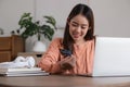 Image of young asian woman order online, shopping from home. Girl enter credit card info on webside to make purchase Royalty Free Stock Photo