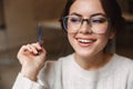 Image of young beautiful caucasian woman smiling and holding pen in cafe Royalty Free Stock Photo