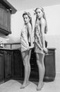 Image of young beautiful funny women pinup girls in dancing first position at the kitchen bar black & white image Royalty Free Stock Photo