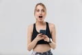 Image of young blond woman 20s dressed in sportswear using smartphone during workout in gym Royalty Free Stock Photo