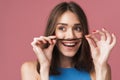 Image of young brunette woman having fun and putting her hair as mustache Royalty Free Stock Photo