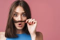Image of young brunette woman having fun and putting her hair as mustache Royalty Free Stock Photo