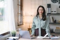 Image of a young, cheerful, happy, positive, cute, and beautiful Asian millennial businesswoman standing indoors in a Royalty Free Stock Photo