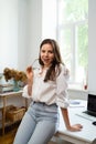 Businesswoman sitting at home and managing her business via home office Royalty Free Stock Photo