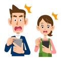 A young couple operating a smartphone with a surprised face