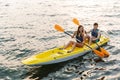 Loving couple kayaking on lake sea in boat