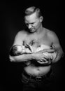 Image of young dad with cute little daughter in his arms. Father and newborn baby child indoor. Royalty Free Stock Photo