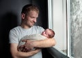 Image of young dad with cute little daughter in his arms. Father and newborn baby child indoor. Royalty Free Stock Photo