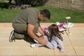 image of a little girl rescued by her father after falling with the bike.