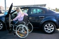 Image of young disabled woman trying to reach her car