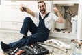 Emotional man plumber take a selfie by mobile phone Royalty Free Stock Photo