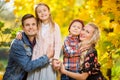 Image of young family with children on walk in autumn park Royalty Free Stock Photo