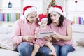 Young family with tablet at Christmas time Royalty Free Stock Photo