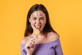 Image of young funny woman liking lollipop and smiling