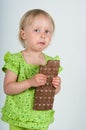 Young girl eating bar of chocolate Royalty Free Stock Photo