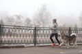 Image of young girl running with her dog, alaskan malamute Royalty Free Stock Photo