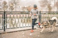 Image of young girl running with her dog, alaskan malamute Royalty Free Stock Photo